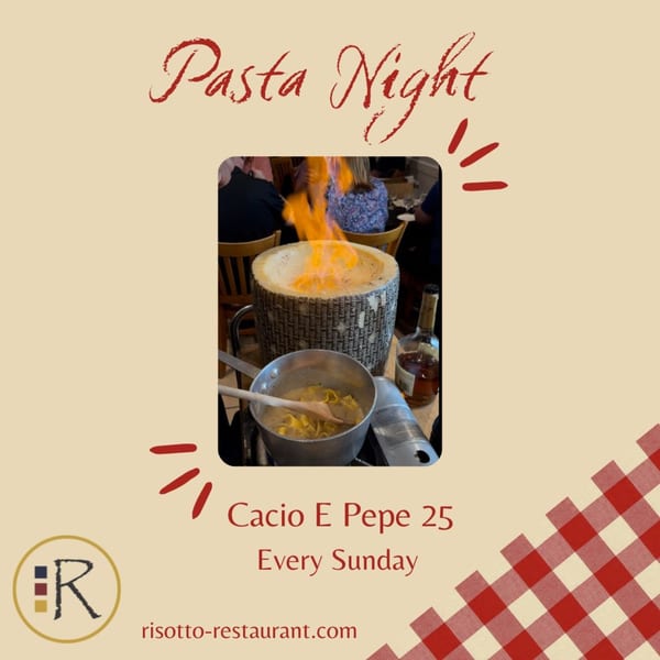 Flambéed cheese wheel with pasta cooking in a pan, for a Cacio E Pepe dish.
